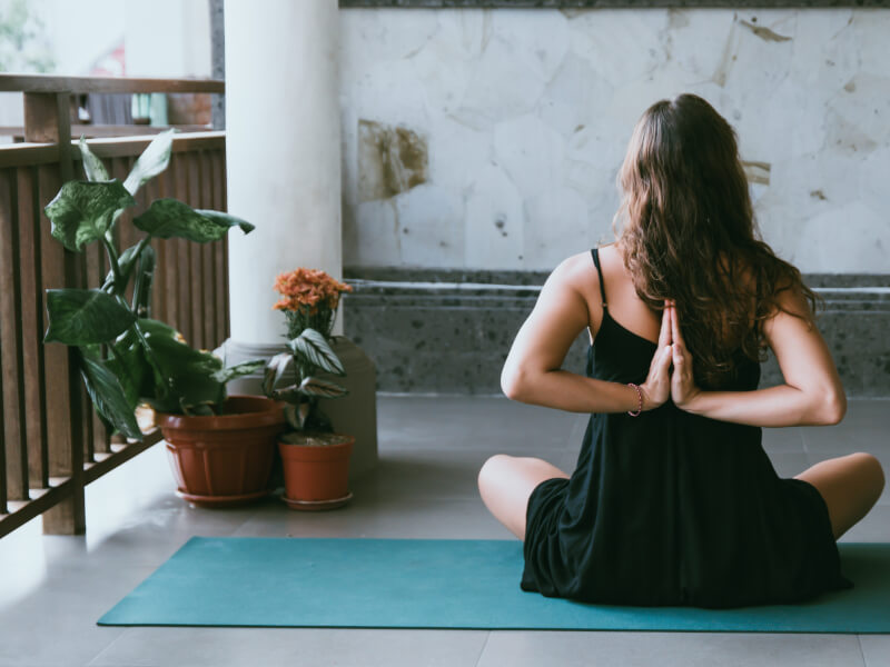 A woman tries yoga at home.